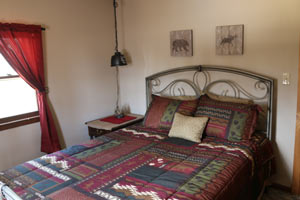 bedroom, red, blue and green bedding